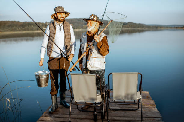 Two veterans bonding while fishing, showcasing camaraderie and friendship.